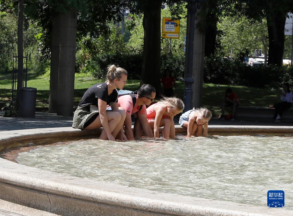 7月8日，人們?cè)诘聡?guó)法蘭克福的一處噴泉玩水。近日，德國(guó)法蘭克福逐漸迎來暑熱天氣。新華社記者 張帆 攝