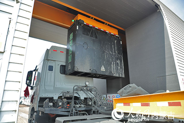 萬利新能源數(shù)字陸港里，正在充換電站進(jìn)行換電的重卡。人民網(wǎng)記者 趙夢月攝