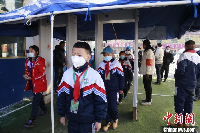 圖為學(xué)生測(cè)量體溫后進(jìn)入校園?！●R銘言 攝