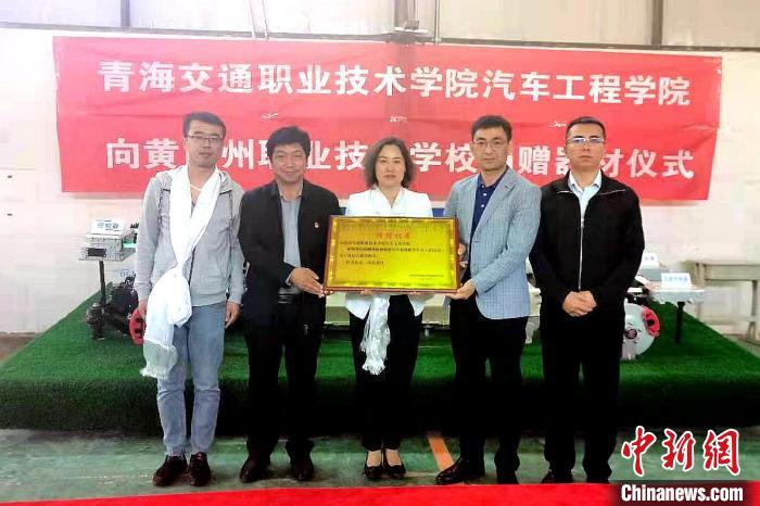 圖為李富香(中)代表學(xué)校為州縣技校捐贈(zèng)器材。(資料圖) 青海省教育廳供圖