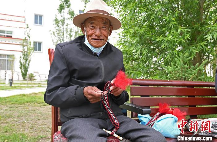 圖為曲松縣特困人員集中供養(yǎng)中心老人在做傳統(tǒng)手工編織?！≮w朗 攝