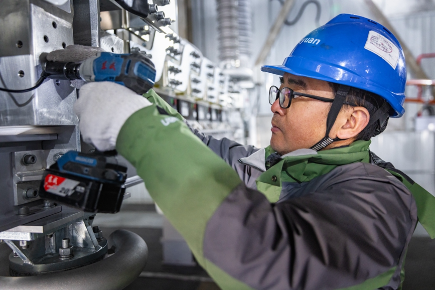 阿里地區(qū)首套電網(wǎng)側(cè)帶超容構(gòu)網(wǎng)型SVG工程現(xiàn)場(chǎng)工作人員正在進(jìn)行投運(yùn)前螺栓緊固工作。趙清鵬攝