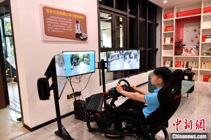 圖為福州中天社區(qū)工作人員正在利用5G技術(shù)，遠(yuǎn)程操控機(jī)器人巡視社區(qū)。　呂明 攝